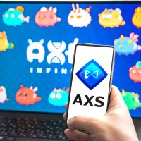 AXS logo on a smartphone and laptop