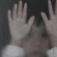 Photo of a child behind a hazy window