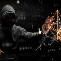 Man in black hood with crypto graphics