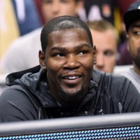 NBA basketball player Kevin Durant sitting among a crowd of spectators