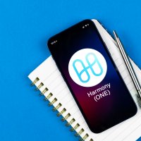 Harmony logo displayed on a phone lying on a notepad