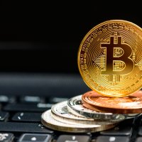 Bitcoin coins on black keyboard