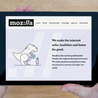 A man looks at the Mozilla website on his iPad tablet device 