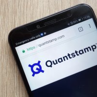 A phone displays the Quantstamp logo and company name