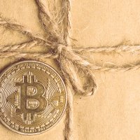 Bitcoin on top of a paper gift box 
