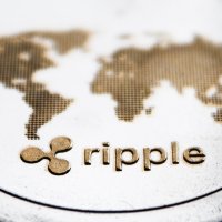 Ripple logo and world map on a coin