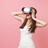 A woman in a wedding dress using a VR headset