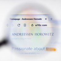 A magnifying glass enlarges the name Andreessen Horowitz and a16z