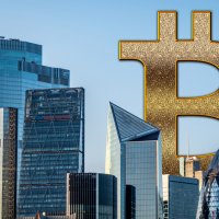 A view of skyscrapers dwarfed by a giant Bitcoin symbol
