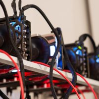 Representation of five cryptocurrency mining rigs in operation