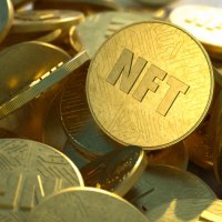 NFTs/non-fungible tokens represented as gold coins, randomly dropped into a large pile, close-up. Embossed circuit design in shiny gold 