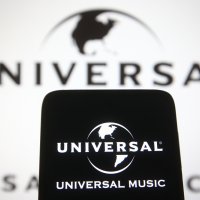 Universal Music Group logo seen on a mobile phone and a computer screen