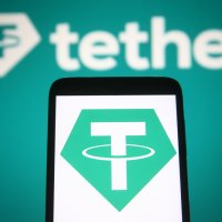 Tether logo, showing a letter T in white on a green hexagon, displayed on a mobile phone screen