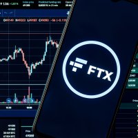 Smartphone displays FTX company name and logo in front of a trading chart