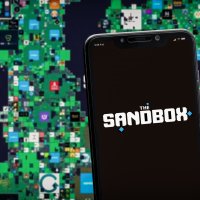 The Sandbox logo on a smartphone