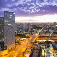 A cityscape of Tel Aviv at sunset