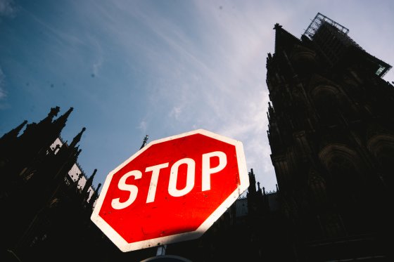 A stop sign in front of Dom Cathedral, Cologne, Germany
