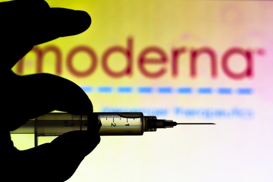 The Moderna logo with a needle in front of it.