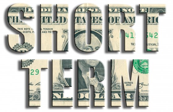Graphic with the words ‘short term’ cut out from a dollar note 