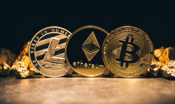 Three coins representing Litecoin, Bitcoin and Ethereum