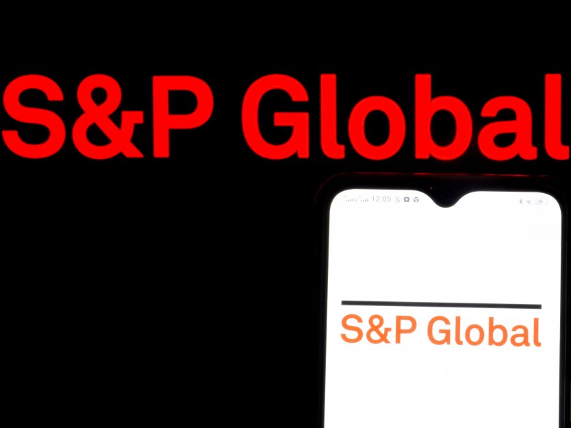 S&P Global logo seen displayed on a smartphone in front of a computer screen