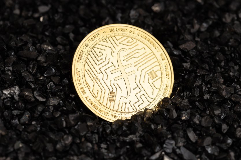 Filecoin coin on black gravel background