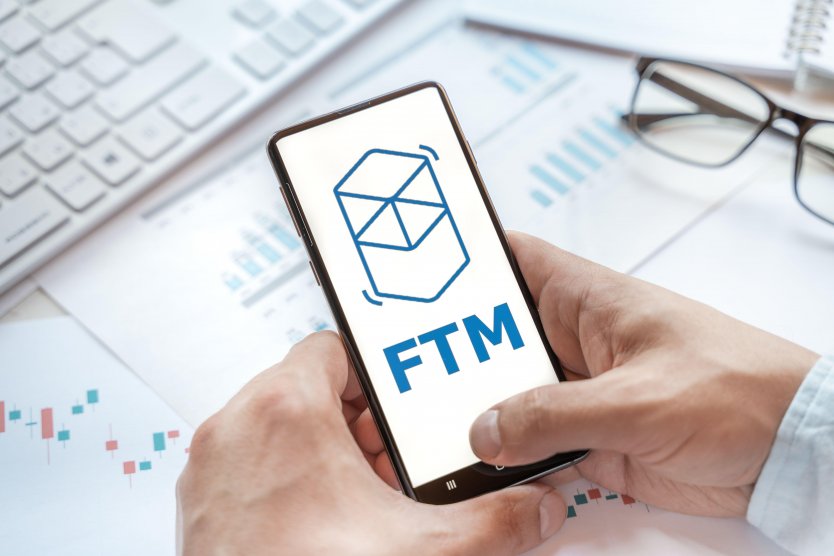 Fantom (FTM) logo on a smartphone