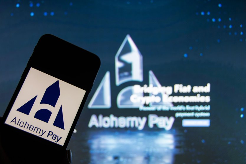 The logo of the cryptocurrency Alchemy Pay on a smartphone and in the background, navy blue with white