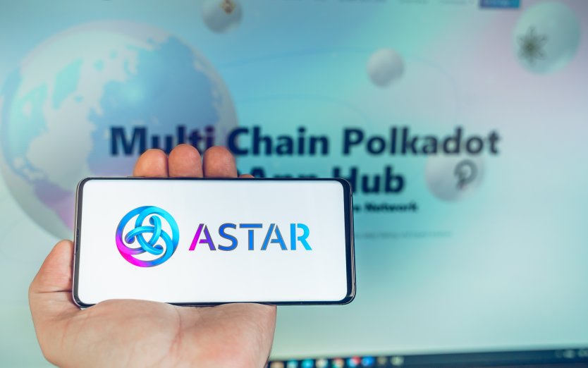 Logo of Astar on a smartphone held in front of a computer screen