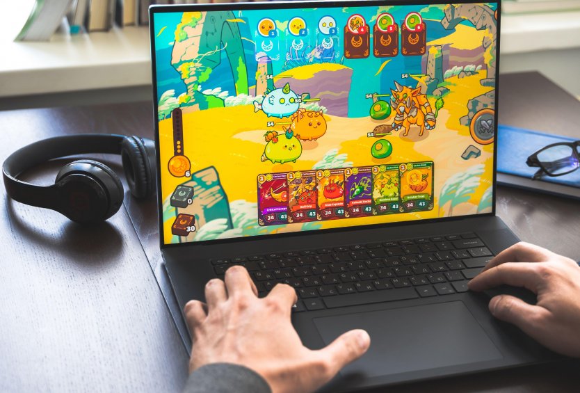Laptop showing an Axie Infinity battle 