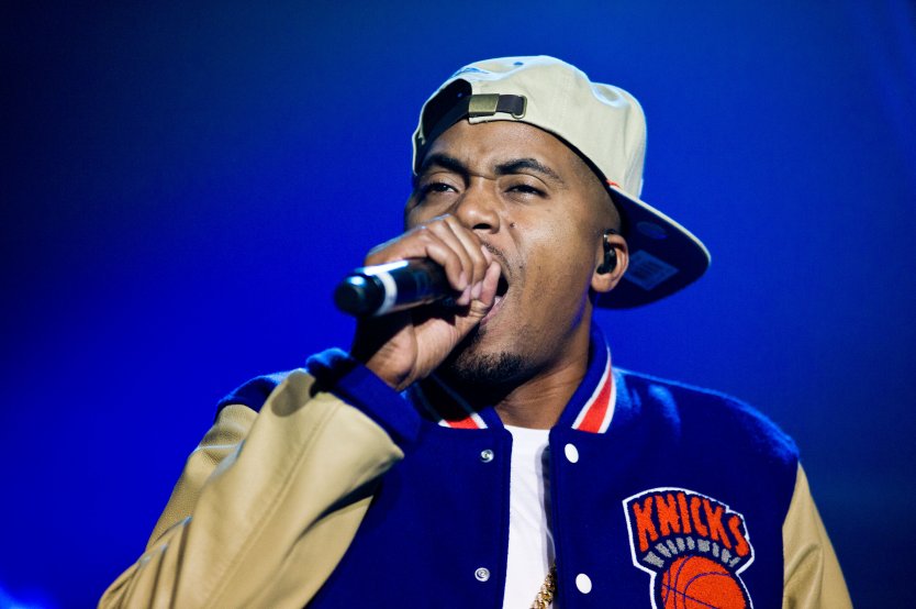 Rap star Nas sings into a microphone