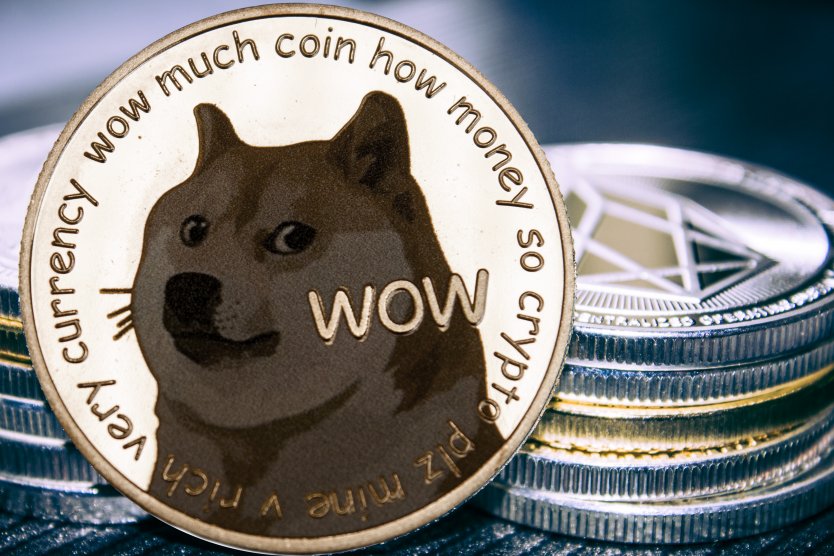 The dogecoin logo on a silver coin