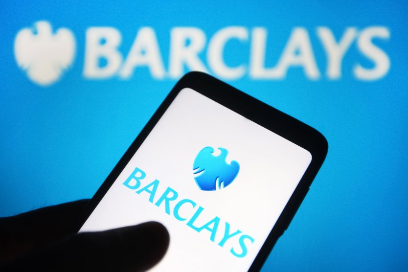 Barclays logo as seen on a smartphone in front of its logo on computer screen