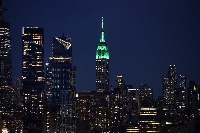 Empire State Building is illuminated in green in Manhattan of New York City, US