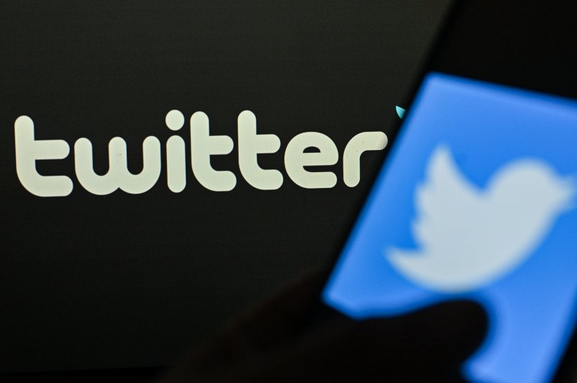 In this photo illustration a Twitter logo is displayed on a smartphone screen