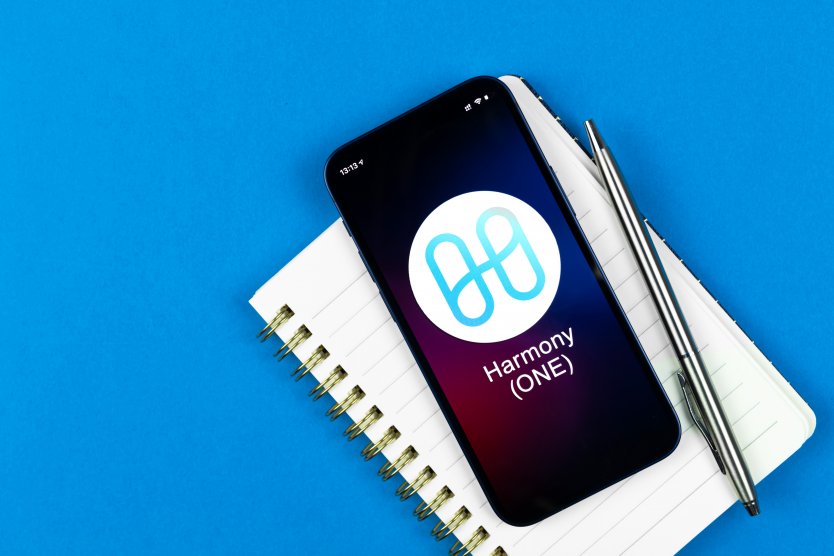 Harmony logo displayed on a phone lying on a notepad