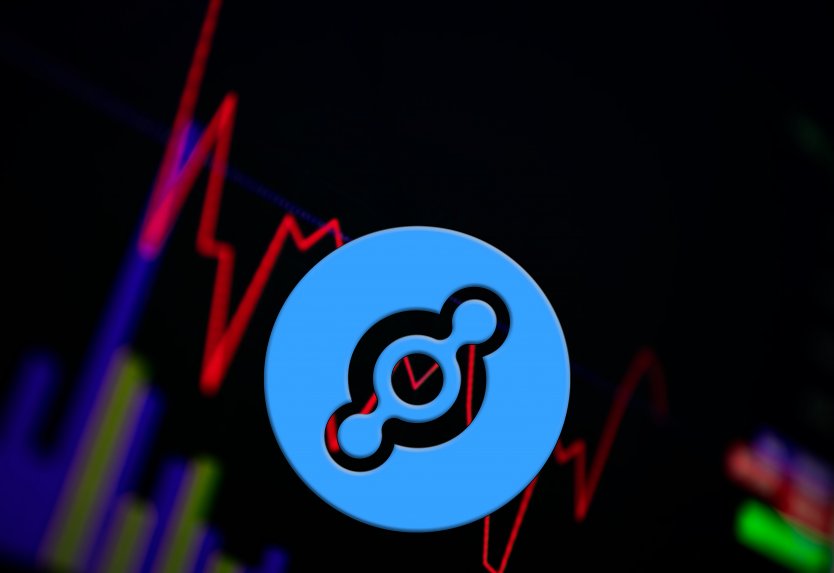 The Helium coin logo in front of a price graph