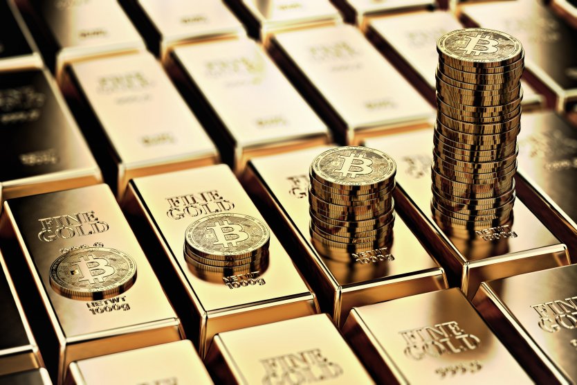 Piles of bitcoin are stacked up on rows of gold bars 