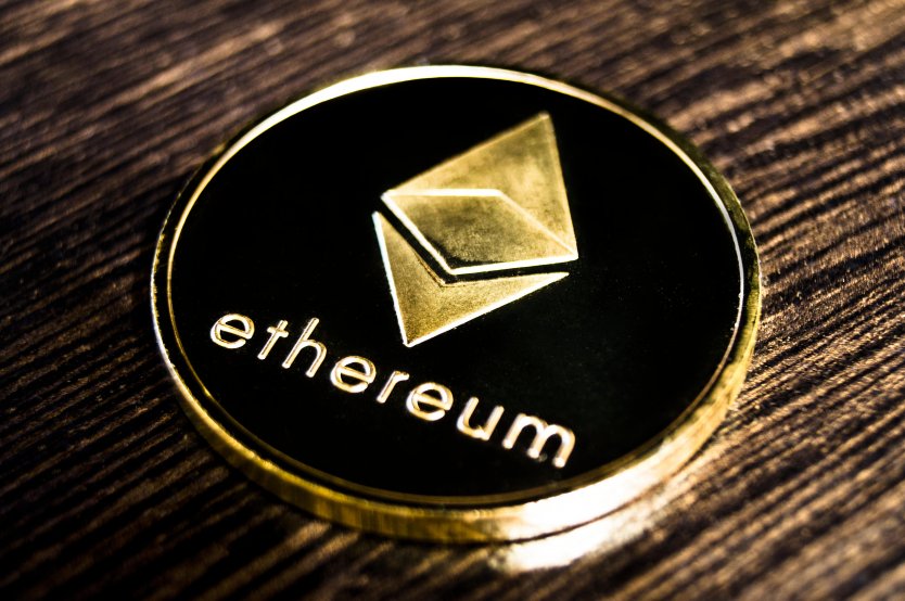 Representation of an ether coin bearing the cryptocurrency’s Ethereum name and logo