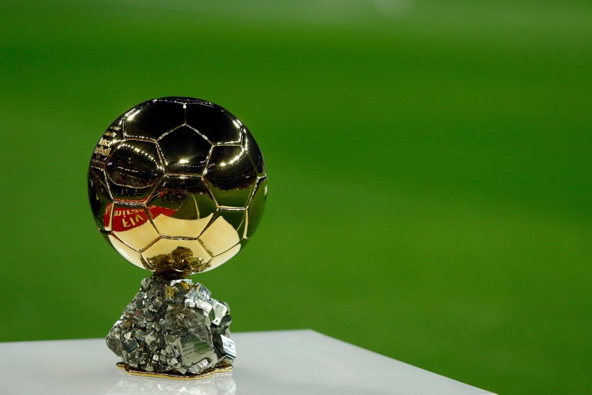 The Ballon d'Or trophy against a green background