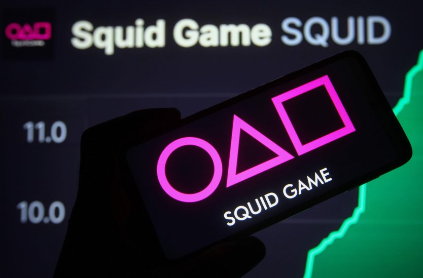 Squid Game logo in front of the coin's price graph