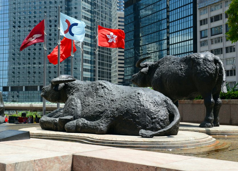Bull sculptures and flags flying outside Exchange Square, home of the Hong Kong Stock Exchange which is currently the third largest stock exchange in Asia