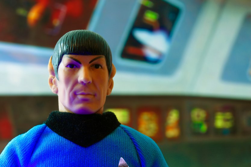 Recreation of a scene from Star Trek the Original Series with a portrait of Mr. Spock at his science station on the bridge of the USS Enterprise - vintage Mego action figure