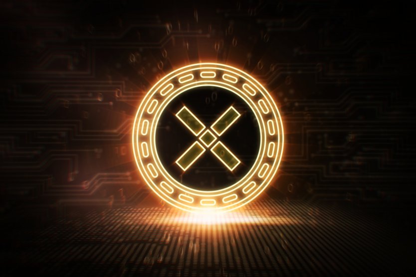 Pundi X logo lit up as a gold disc on a black background