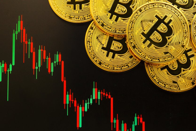Golden Bitcoins with a cryptocurrency trading chart