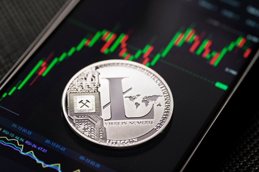 Representation of a lite coin (LTC) on a smartphone displaying a trading chart