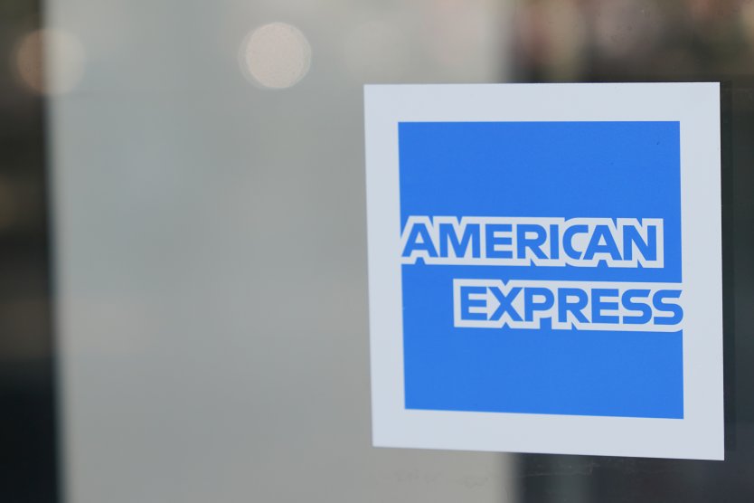 A sticker on glass displays the blue and white American Express logo
