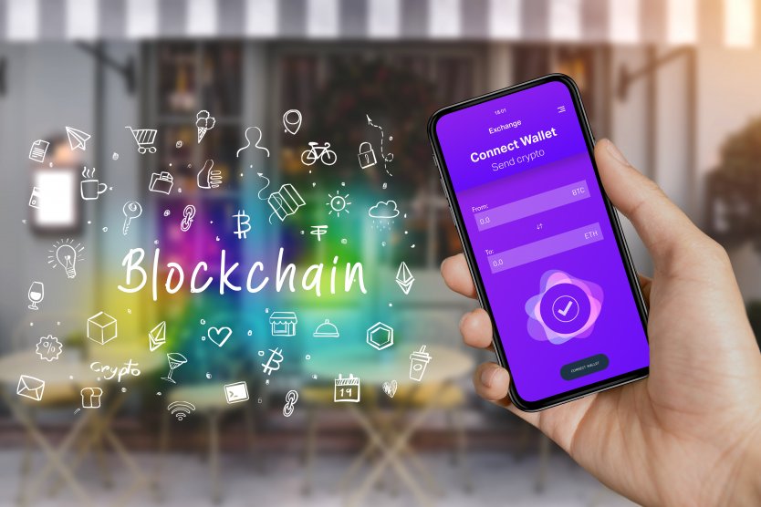 Hand holding a smartphone, next to icons for dApps and blockchains 
