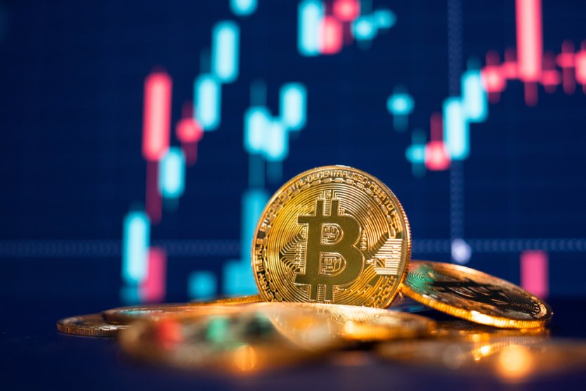 Bitcoin (BTC) coins against a chart backdrop