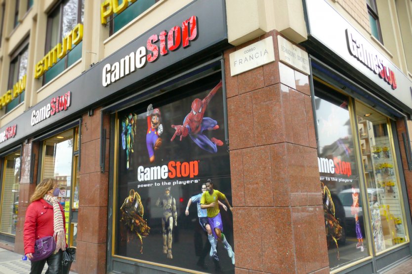 Exterior of a GameStop retail store with a window display of video game characters